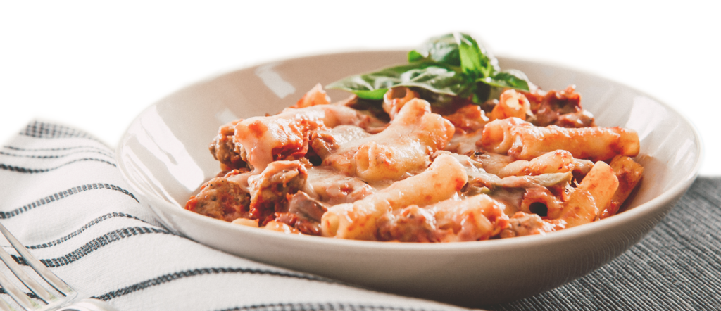 bowl of pasta with basil on top