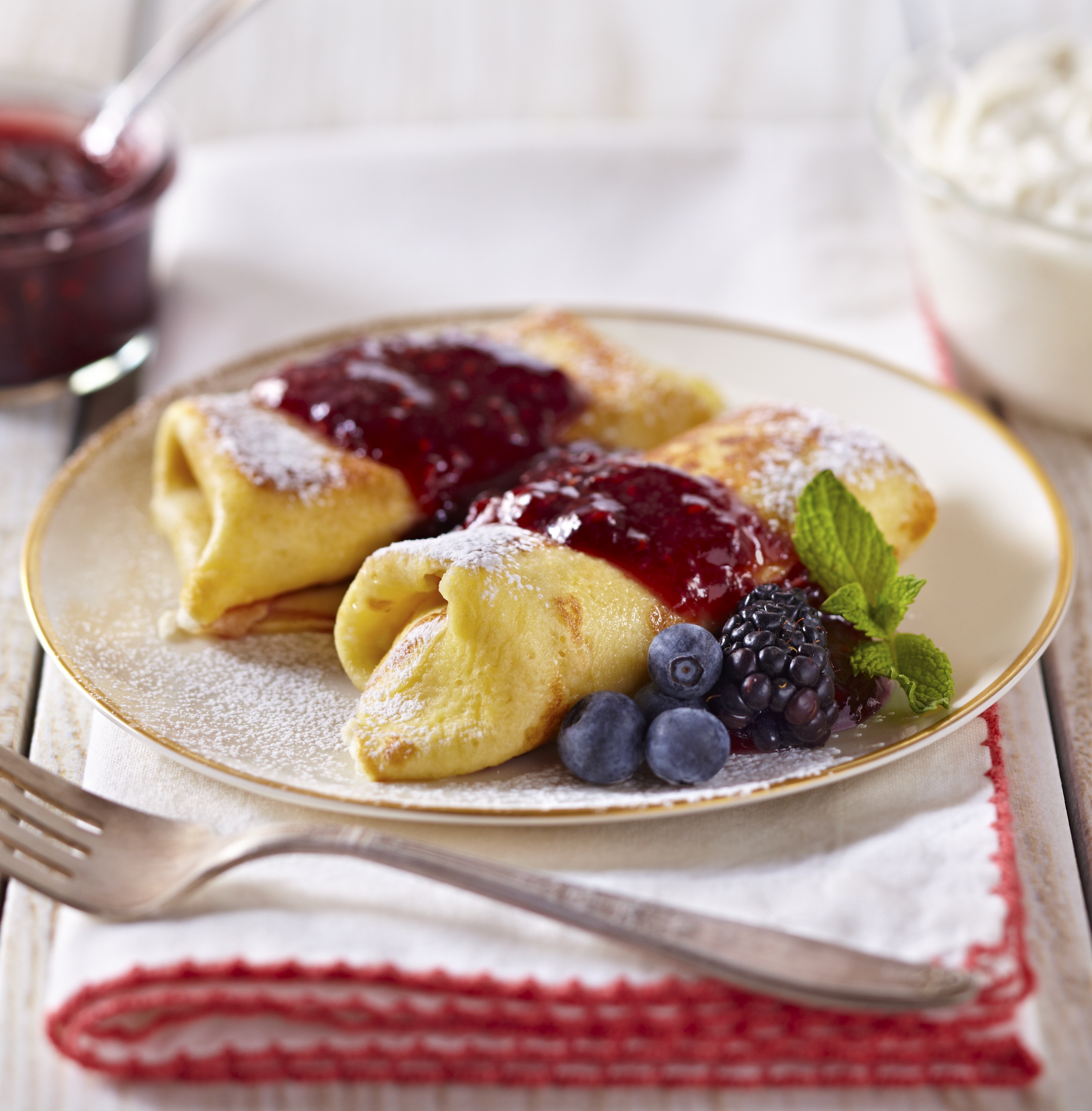 Cheesecake Blintzes with fruit on a plate
