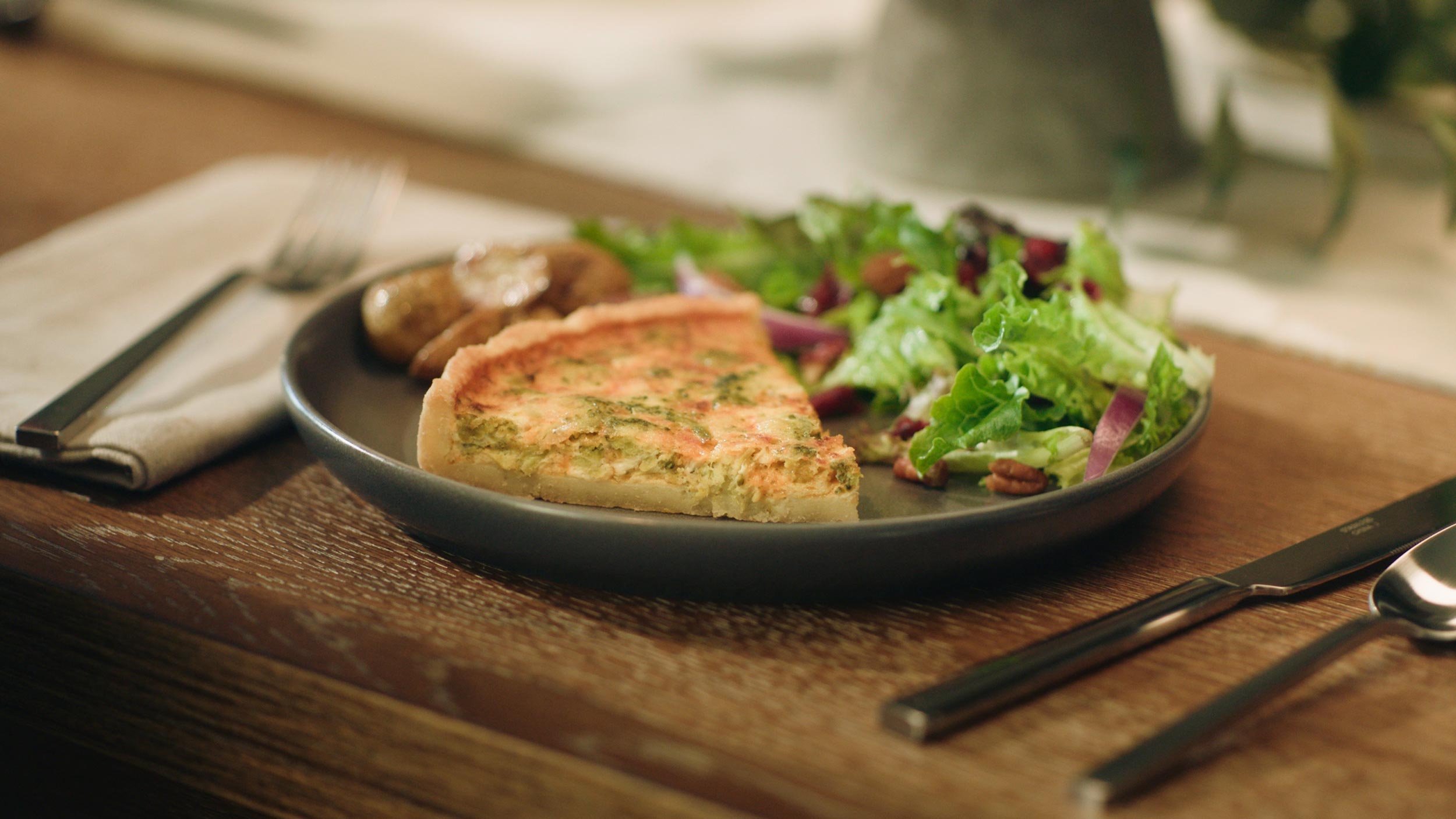 quiche on a plate with salad