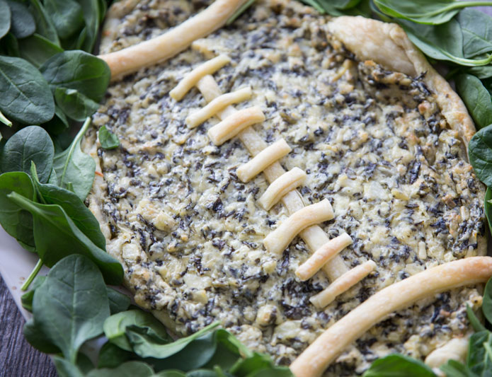 Football Spinach & Artichoke Dip on a bed of spinach