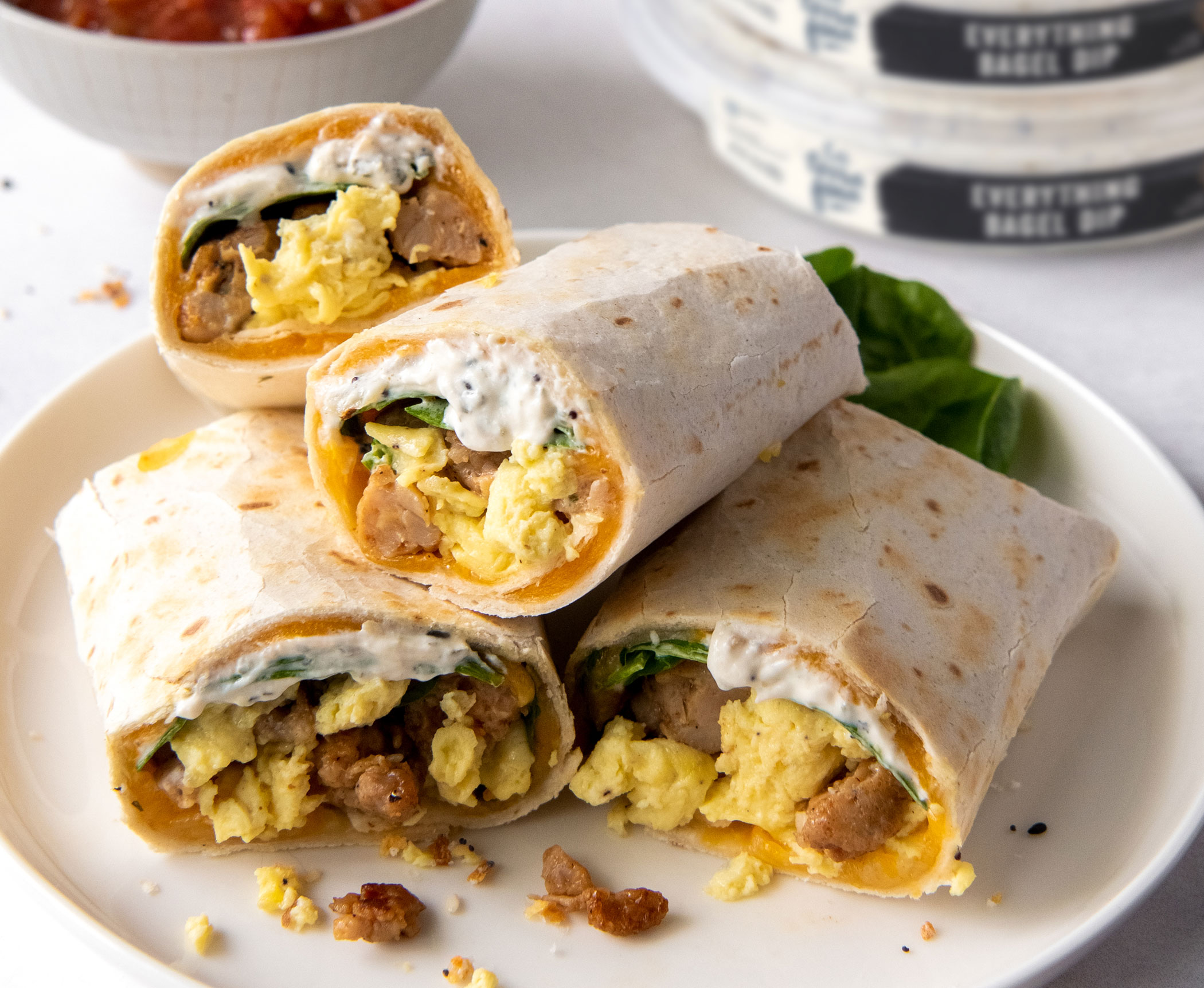 everything bagel burritos stacked on a plate