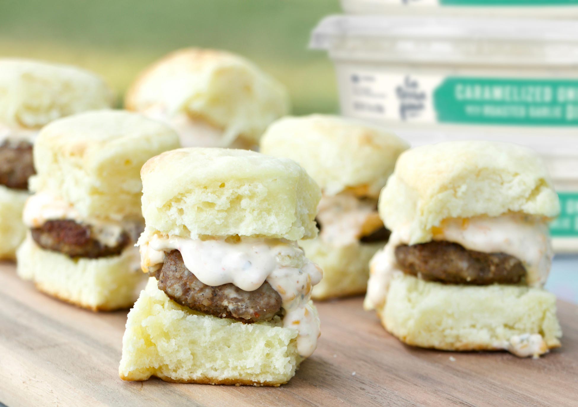 multiple mini sausage and cheese biscuits on a table
