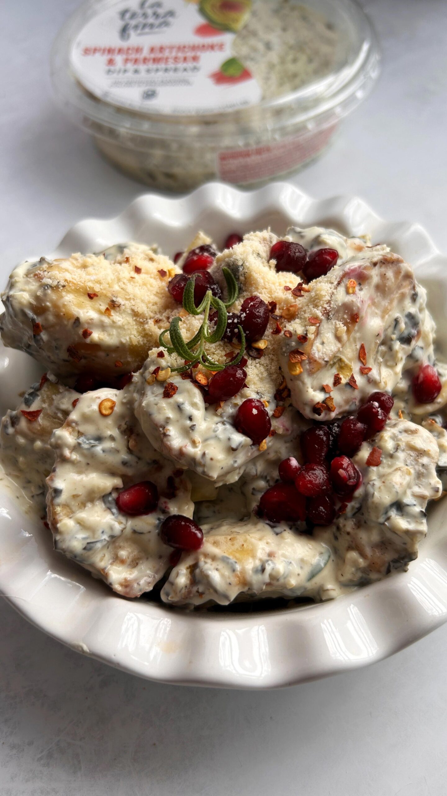 Bowl of Spinach Artichoke Potato Salad with Pomegranate & Rosemary