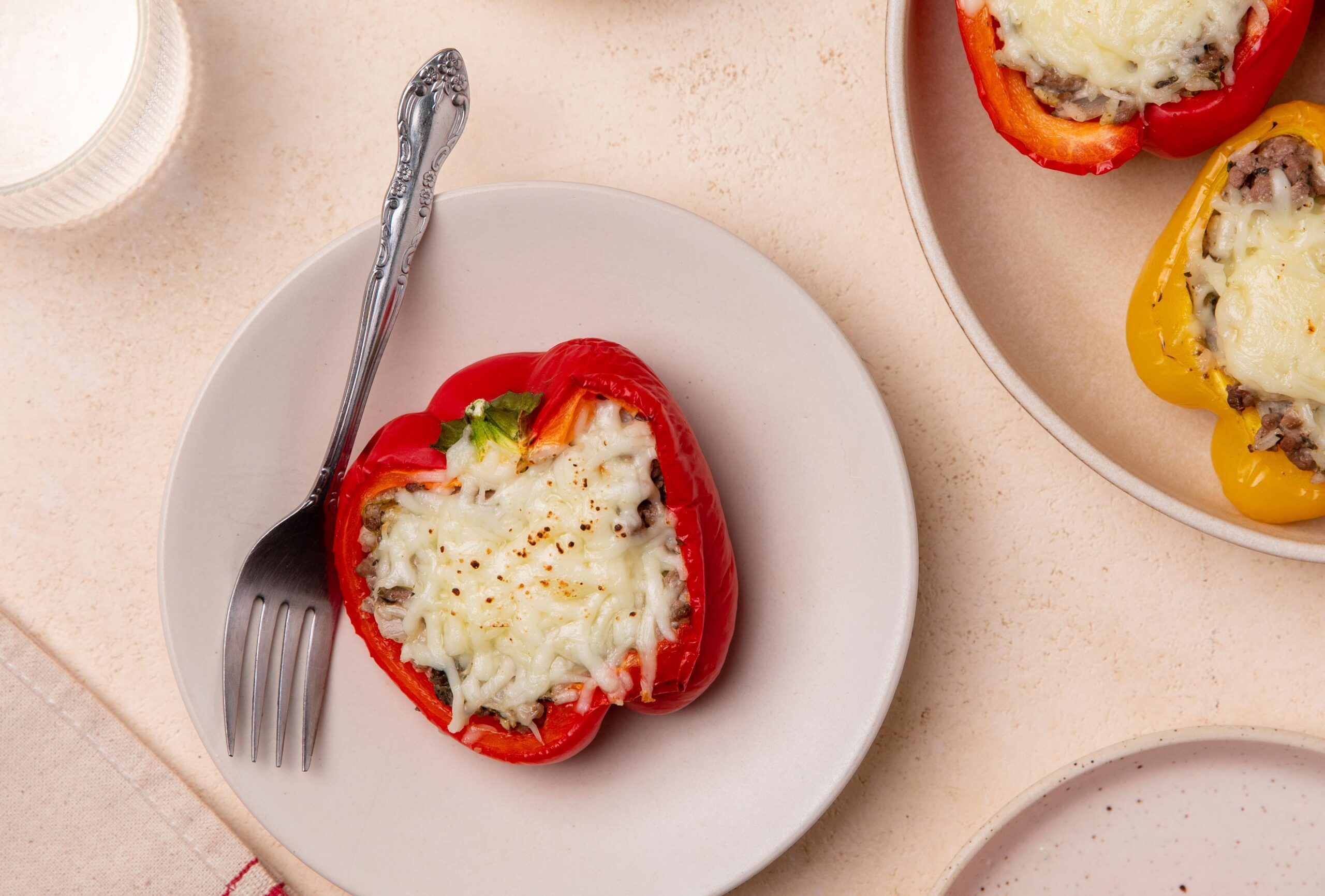 stuffed pepper on a white plate with a fork